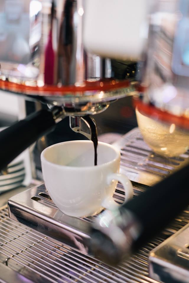 Coffee from a machine into a cup