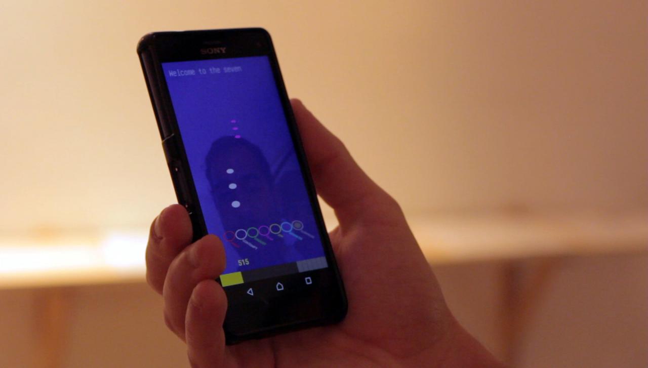 A hand holding a cell phone with a blue screen