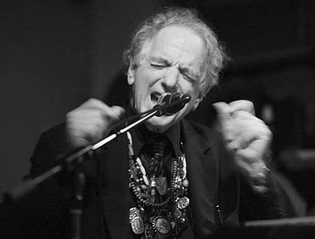 David Amram singing in a mikrophone