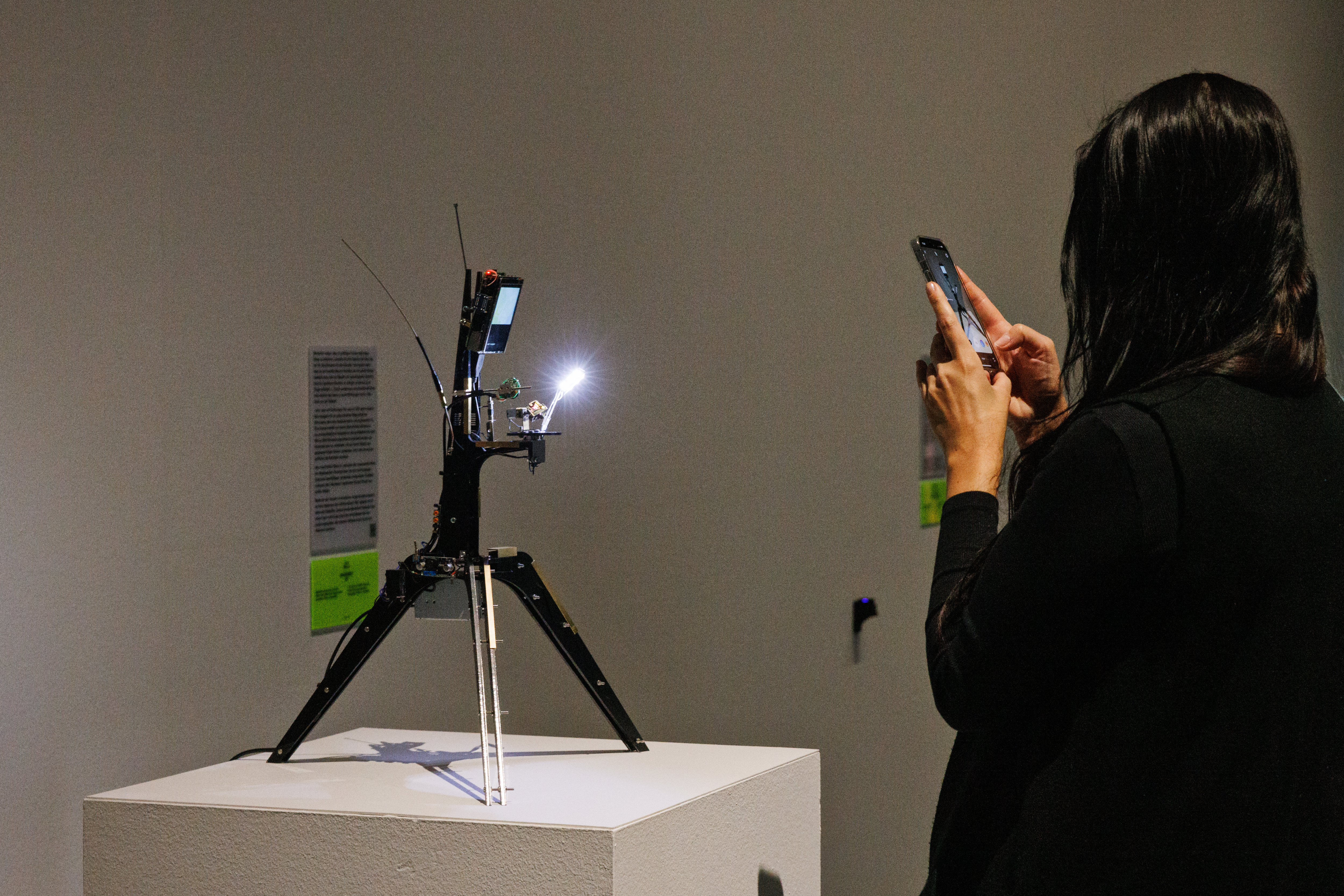 You can see a camera on a tripod filming a crystal.