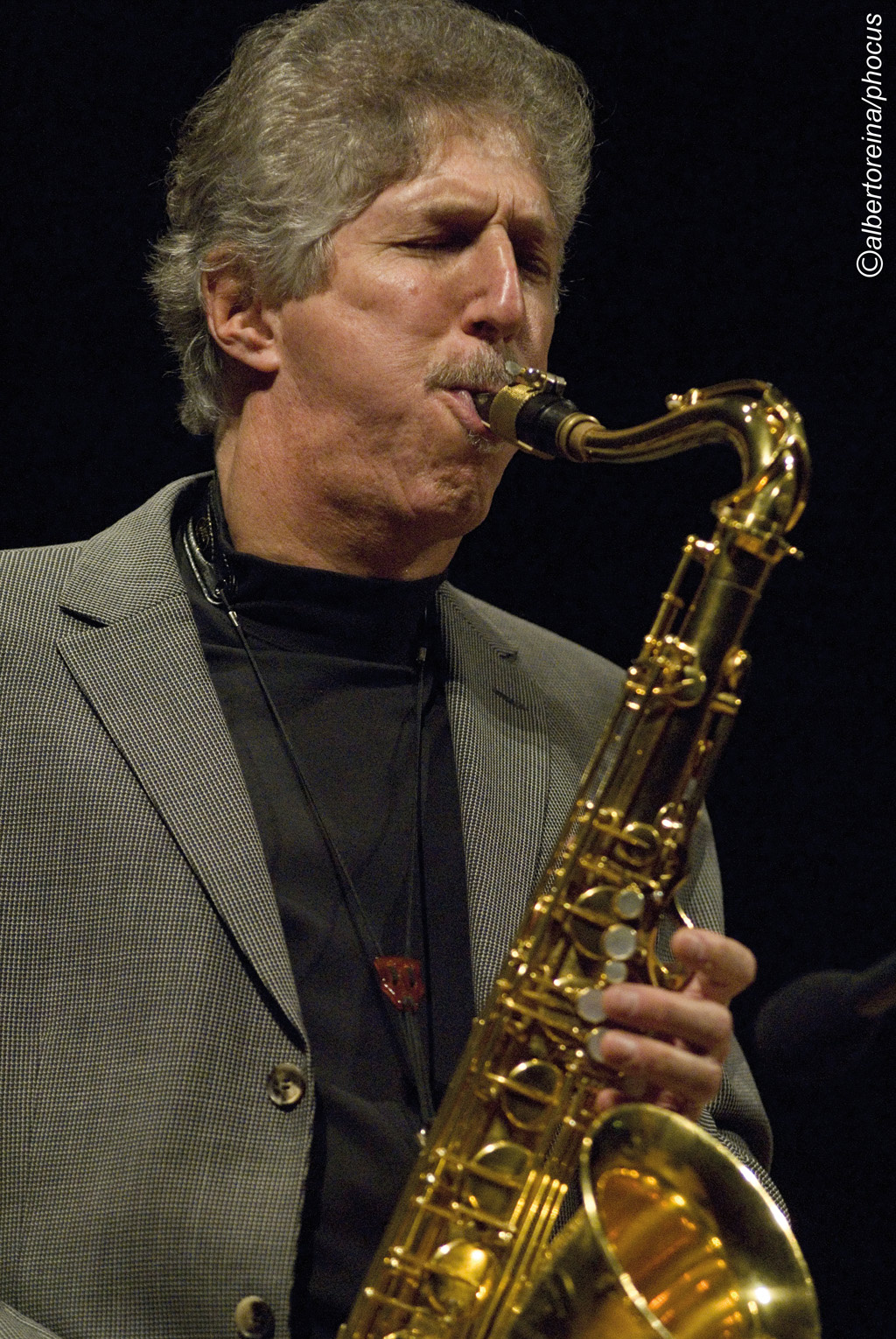 A man playing the saxophone.