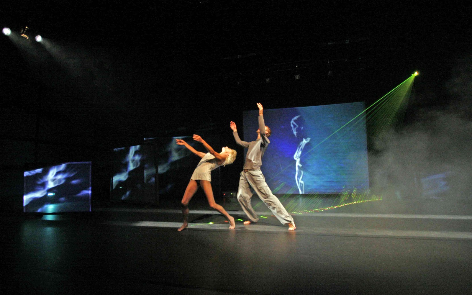 Two persons on a stage with light effects