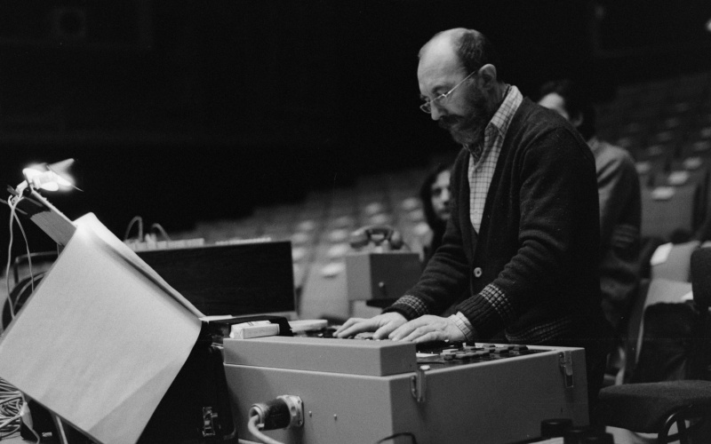 A man standing at a sound mixer