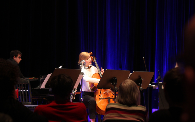 A young woman plays cello