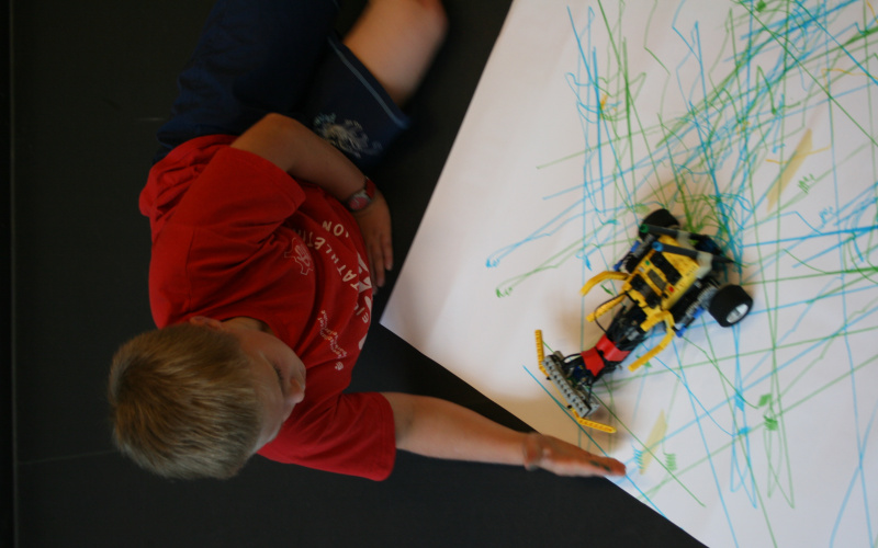 A robot equipped with a sensor is identifying an obstacle - the hand of a child that is holding it in front of the robot.