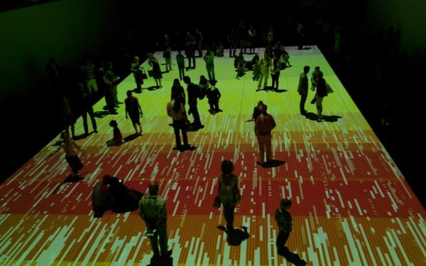 People standing on a colored projection