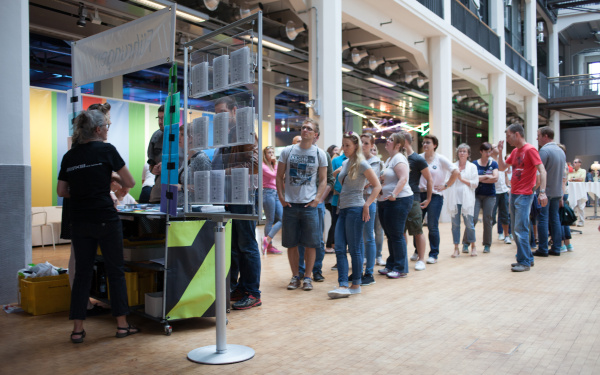 A crowd in front of a stand