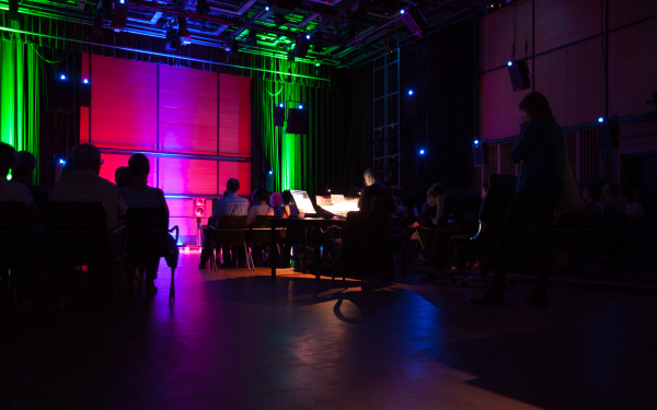 A room dipped in pink and green light