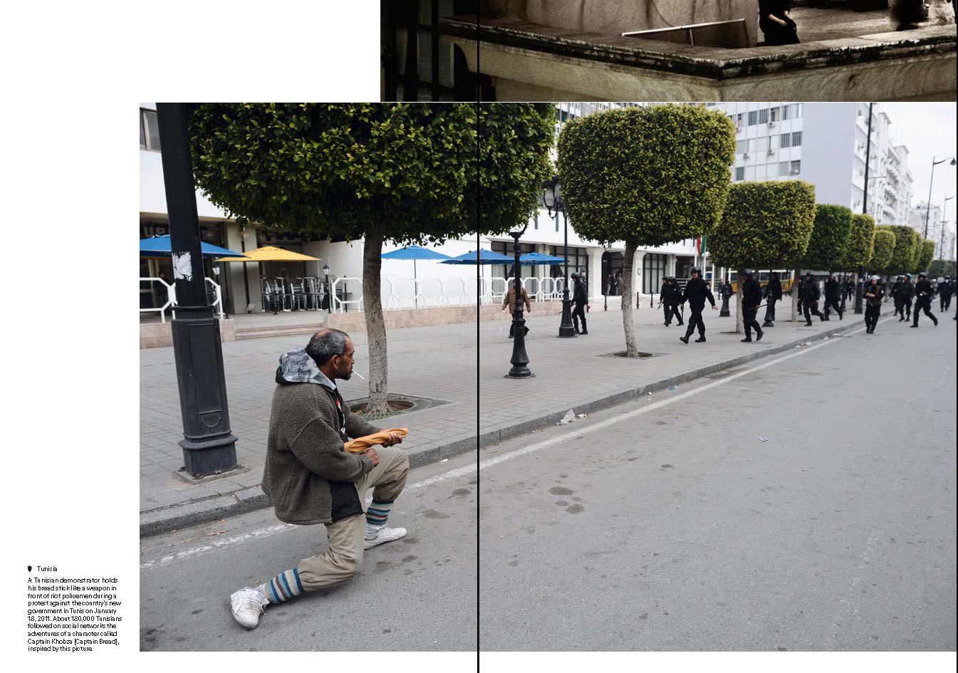 Man holding a bread as if it was a gun.