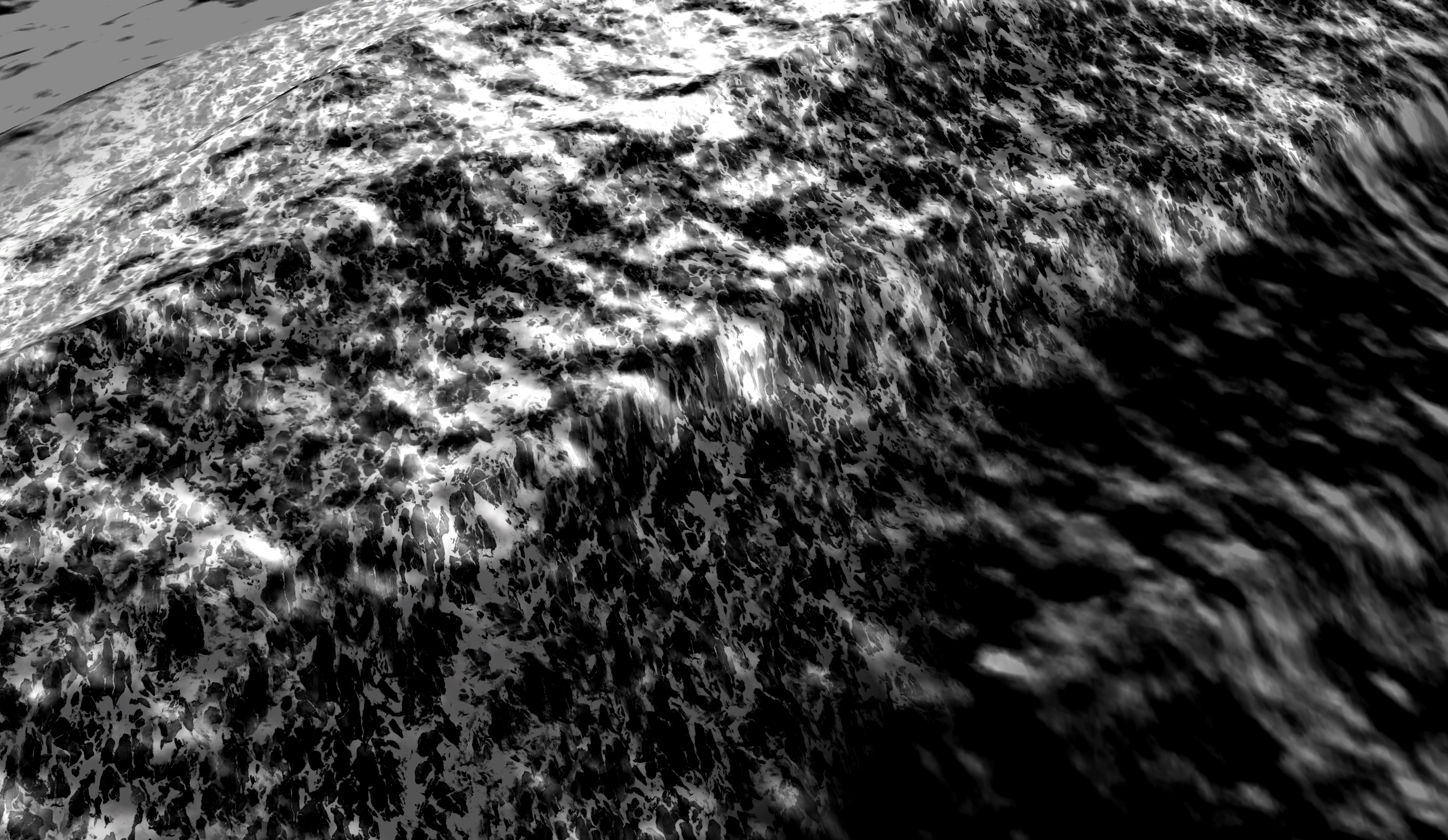 The image shows a black and white top view of a moving sea.