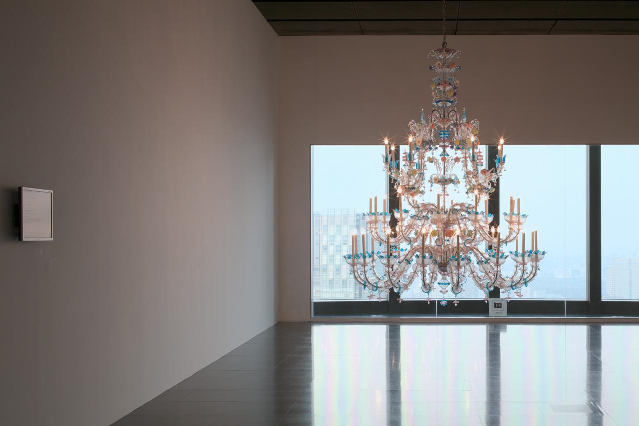 Colorful chandelier in a room in front of a glass wall