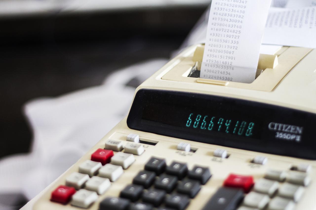 Close-up of a cash register with printed receipt