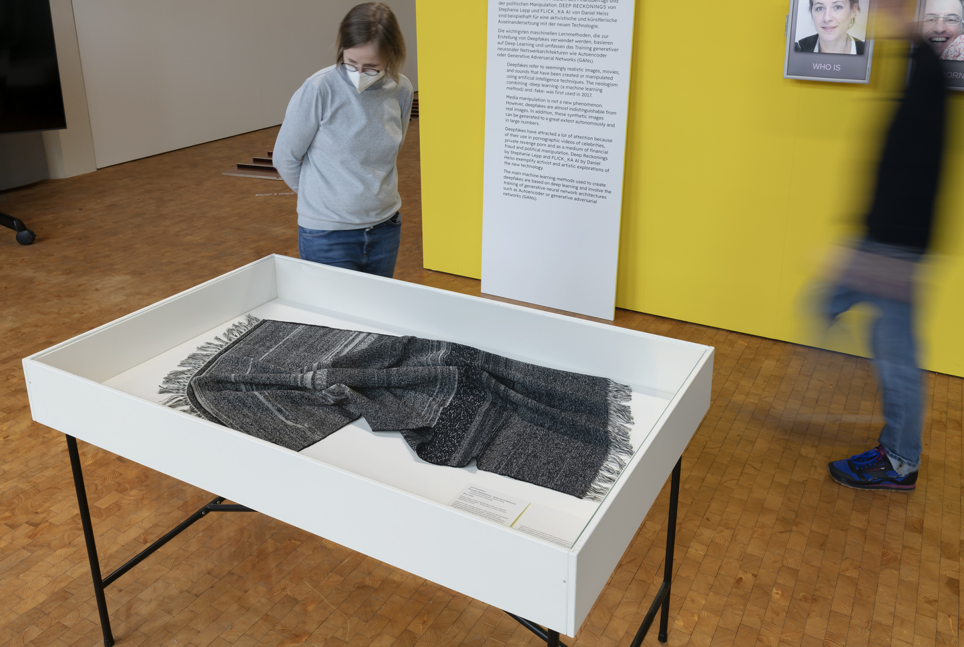 A scarf lying in a glass box