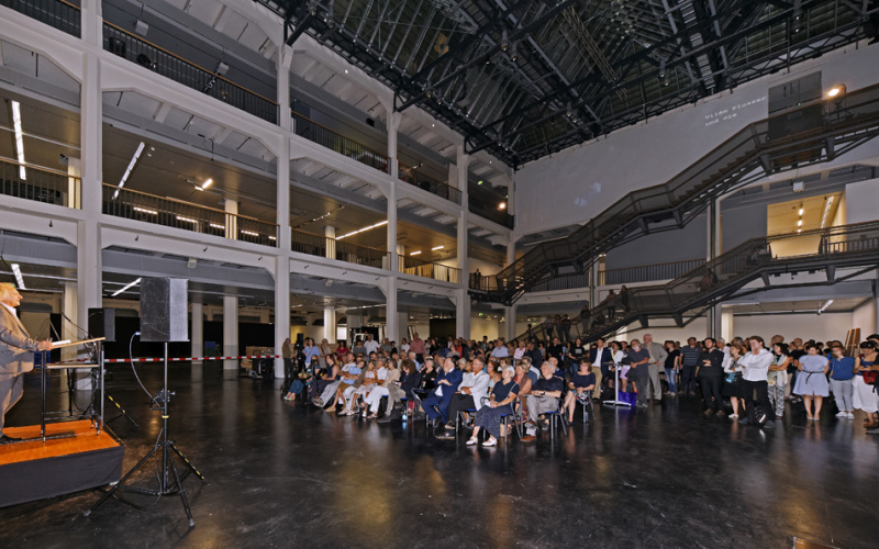 A man standing in front of a sitting crowd