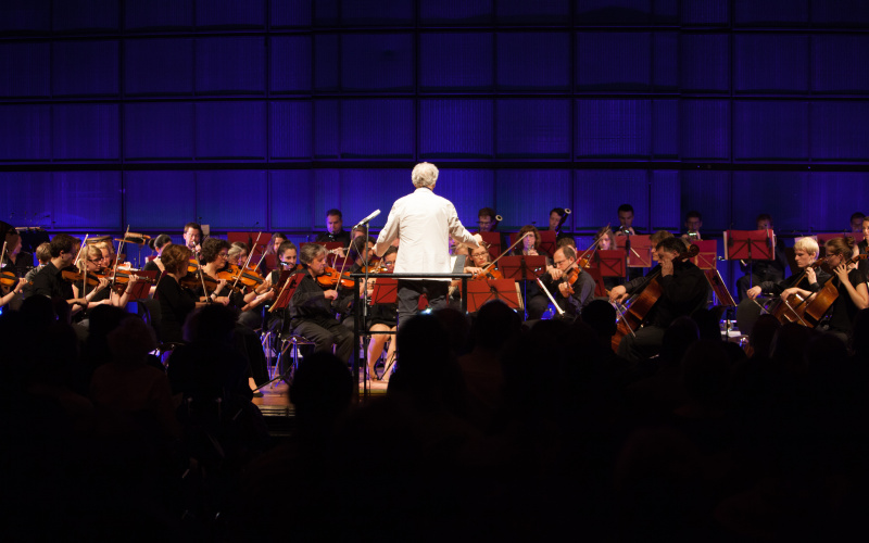 David Amram in front of an orchestra