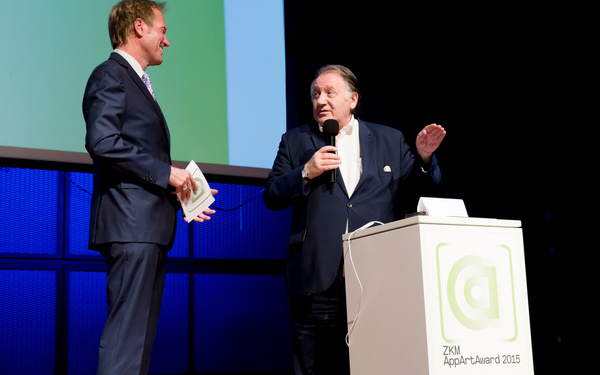 Two men talking to each other on stage