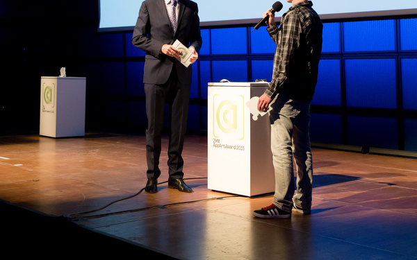 Two men talking to each other on stage