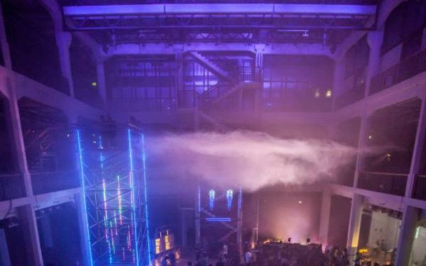 People dancing under a cloud in a closed room